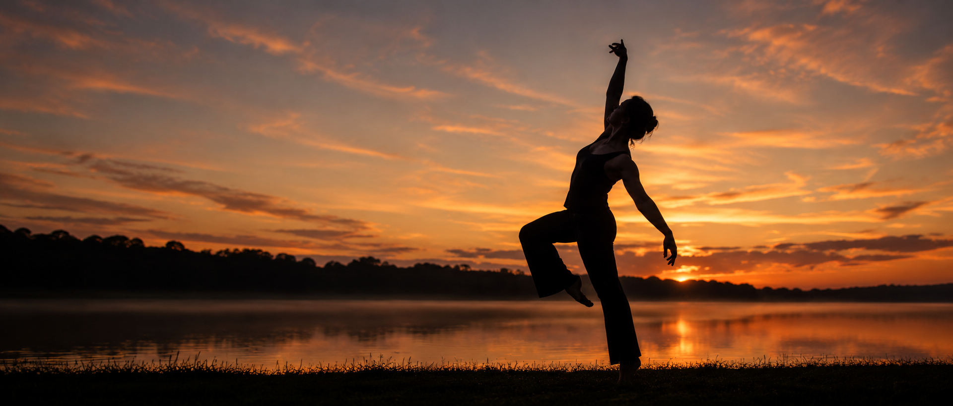 Abigail dancing solo in front of a sunset